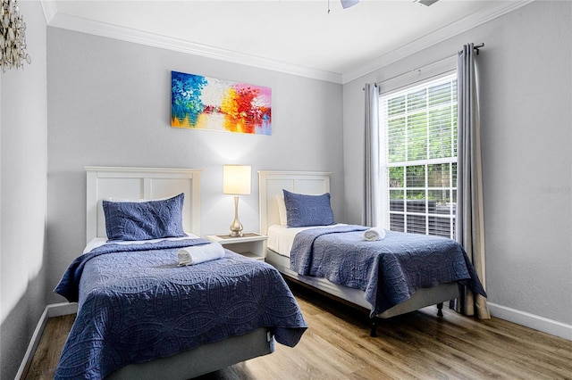 bedroom with ceiling fan, hardwood / wood-style floors, and ornamental molding