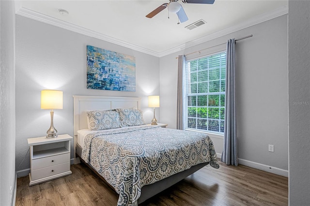 bedroom with ceiling fan, dark hardwood / wood-style floors, and ornamental molding