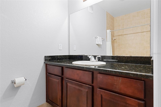 bathroom featuring vanity and curtained shower