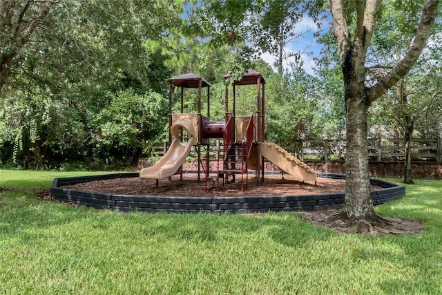 view of playground with a lawn