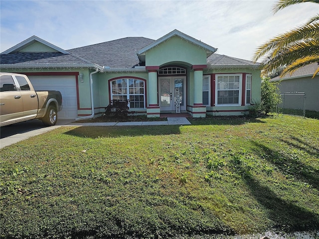 view of front of home featuring a front yard and a garage