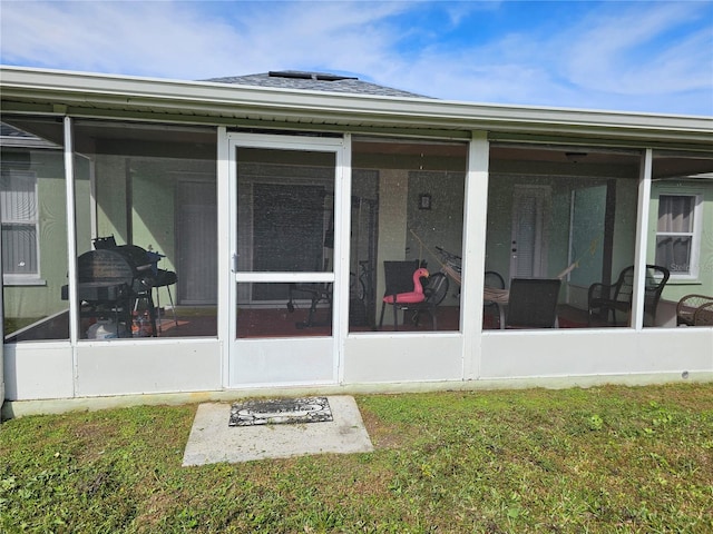 back of house with a yard and a sunroom