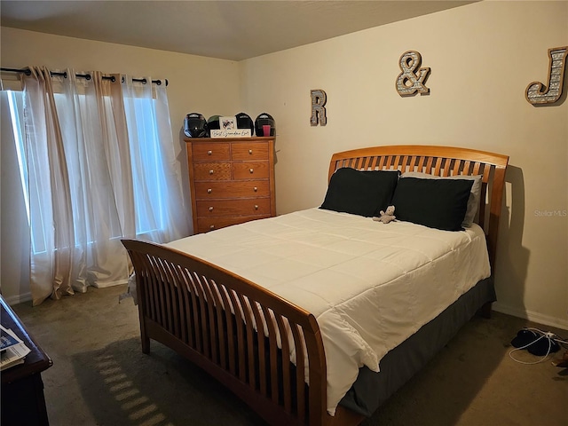 bedroom featuring dark colored carpet