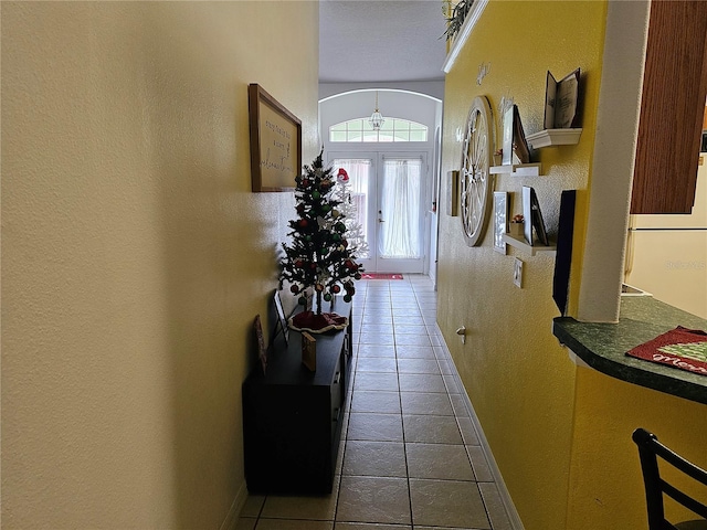 entryway featuring tile patterned flooring and french doors