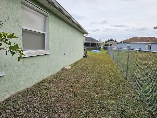 view of yard featuring a sunroom