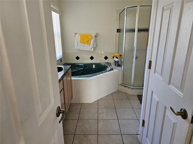 bathroom featuring vanity, independent shower and bath, and tile patterned floors