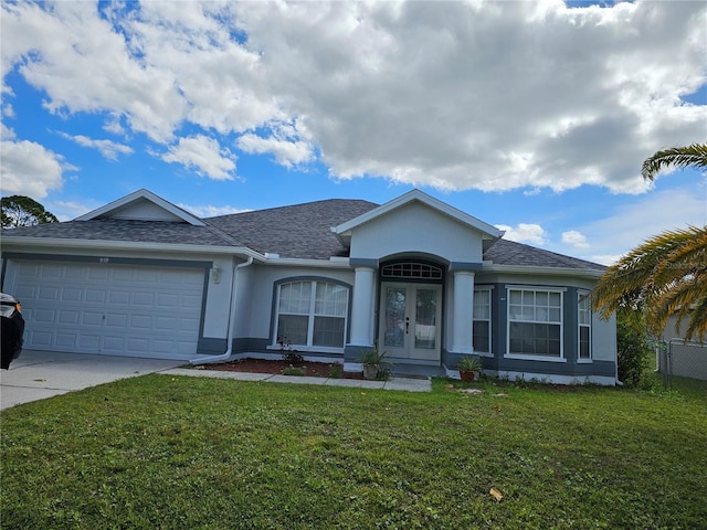 single story home with a front yard, french doors, and a garage