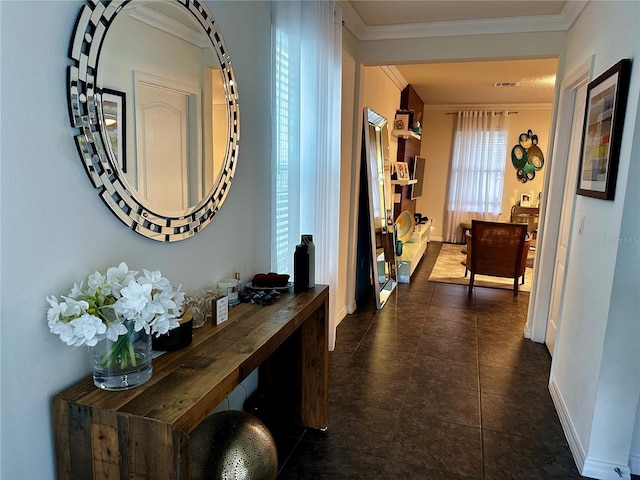 corridor featuring dark tile patterned flooring and ornamental molding