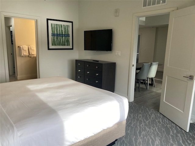 bedroom with dark wood-type flooring