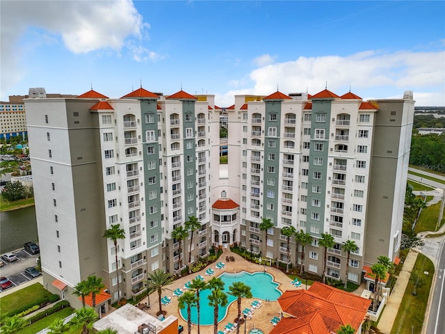 view of building exterior featuring a community pool