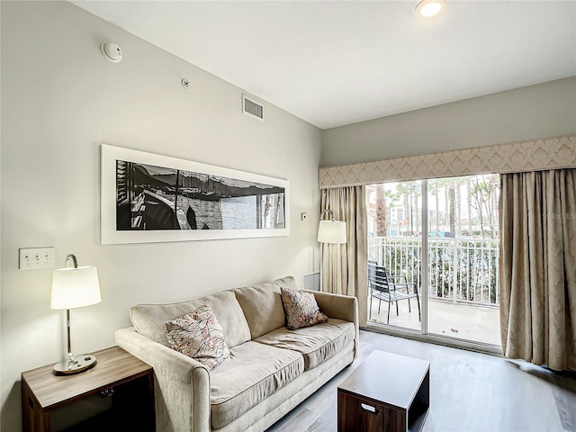 living room featuring visible vents and wood finished floors