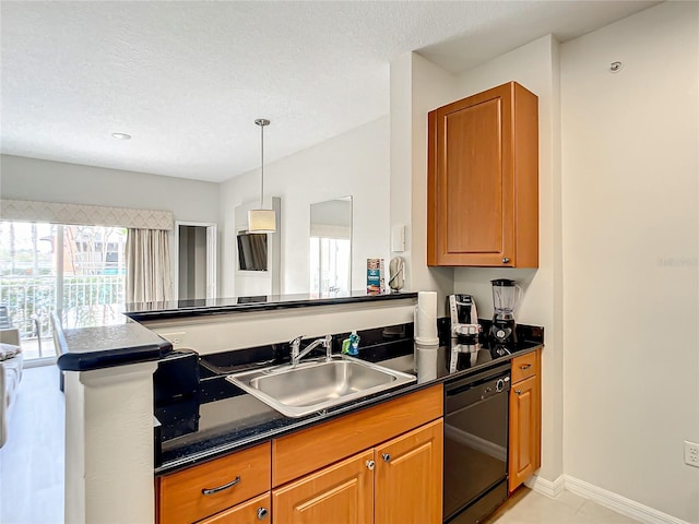 kitchen with black dishwasher, dark countertops, brown cabinetry, a sink, and a textured ceiling