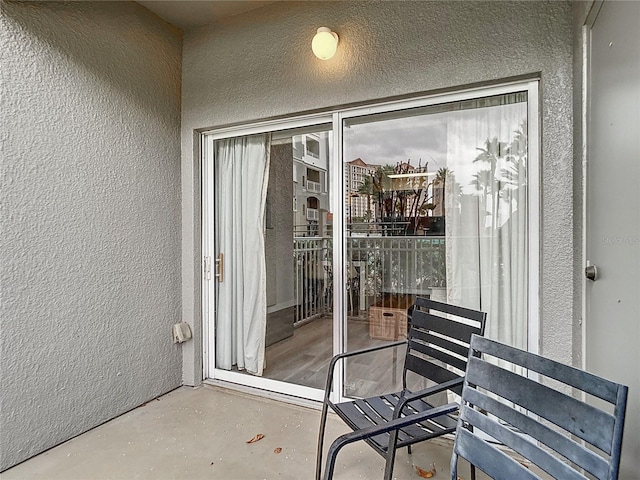 view of exterior entry featuring stucco siding