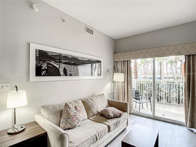 living room with visible vents and wood finished floors