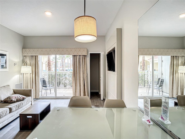 living area with visible vents and wood finished floors