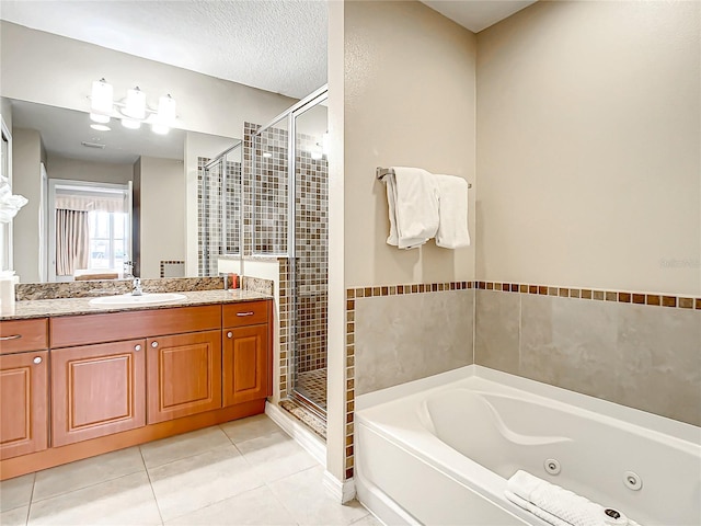 bathroom with a stall shower, vanity, a whirlpool tub, and tile patterned floors