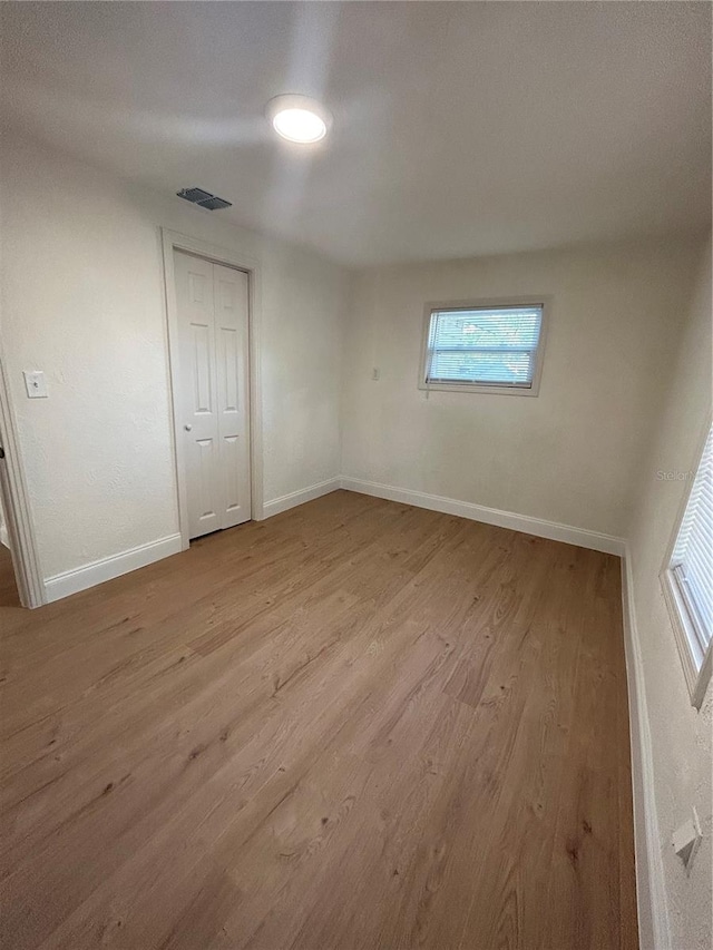 empty room with light hardwood / wood-style floors