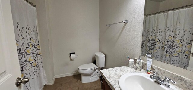 bathroom with vanity, a shower with curtain, baseboards, tile patterned floors, and toilet