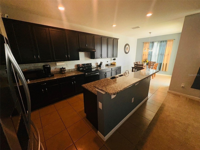 kitchen featuring dark stone countertops, dark tile patterned flooring, recessed lighting, decorative backsplash, and black electric range oven