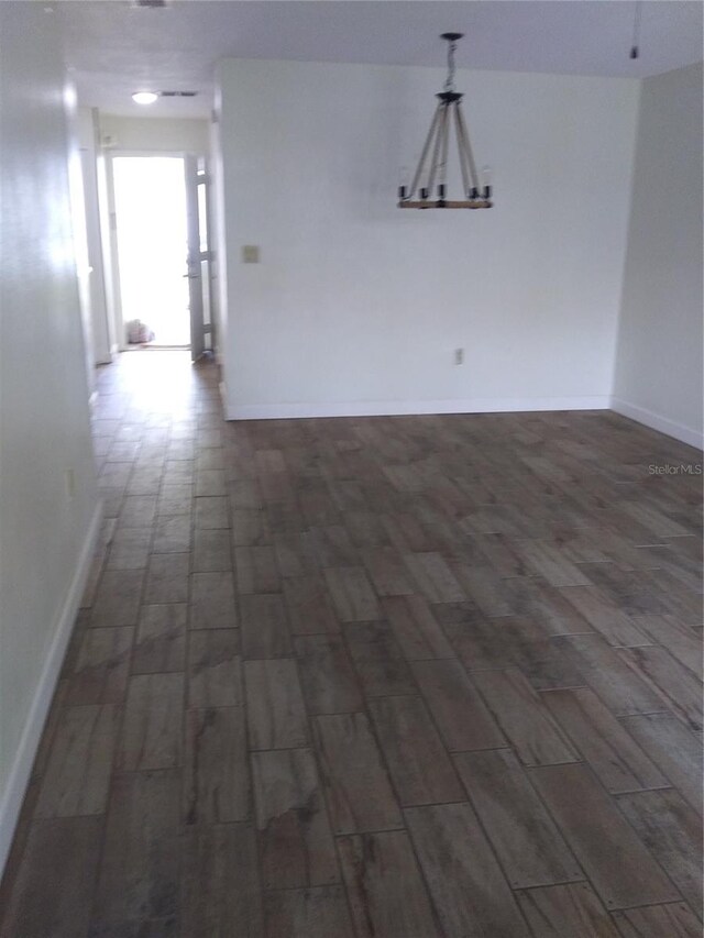 empty room with dark hardwood / wood-style flooring