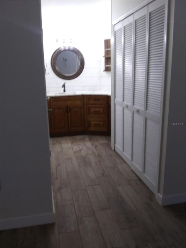 hallway featuring sink and dark hardwood / wood-style flooring