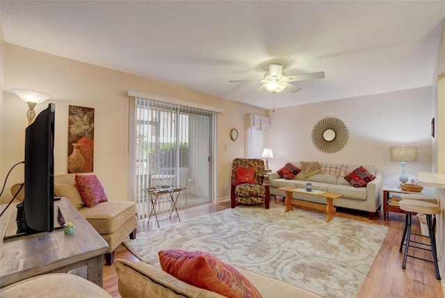 living room with ceiling fan and light wood-type flooring