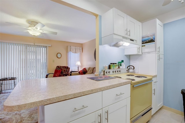 kitchen featuring white range with electric cooktop, white cabinets, ceiling fan, light tile patterned floors, and kitchen peninsula