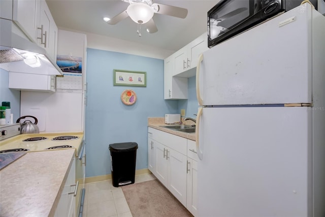 kitchen featuring white appliances, ceiling fan, sink, white cabinetry, and light tile patterned flooring