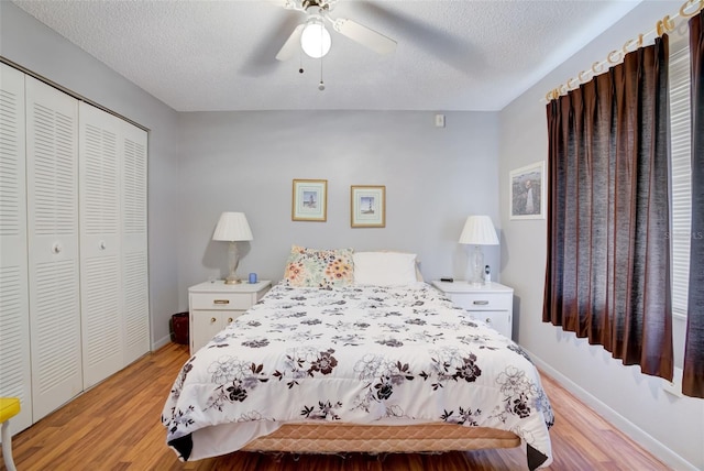 bedroom featuring ceiling fan, a closet, light hardwood / wood-style floors, and a textured ceiling