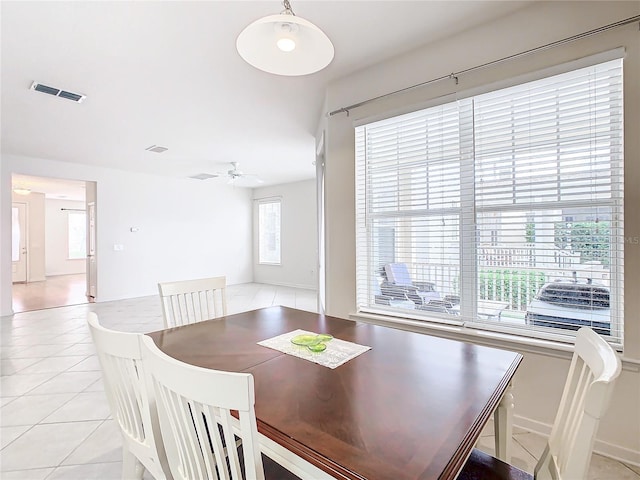 dining space with ceiling fan and light tile patterned flooring