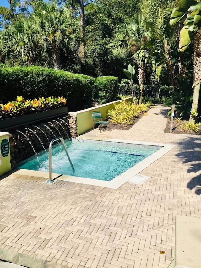 view of pool featuring pool water feature