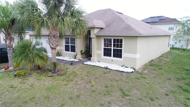 rear view of property with a lawn