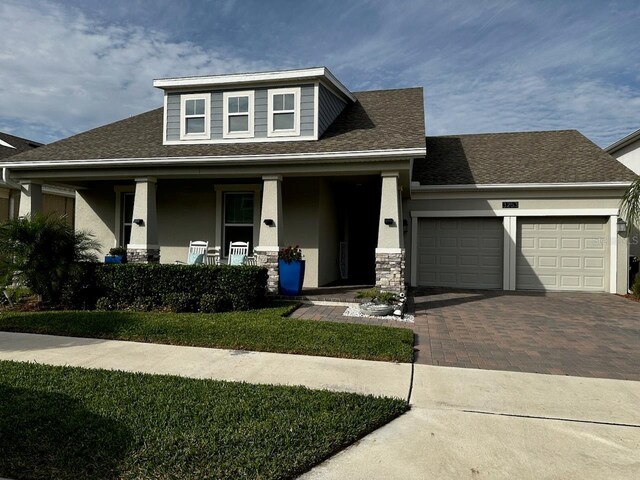 view of front of home featuring a garage and a porch