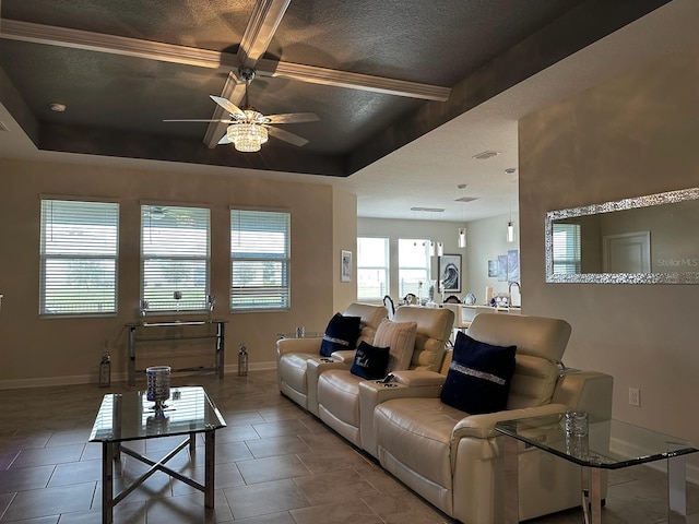 tiled living room featuring ceiling fan and a tray ceiling