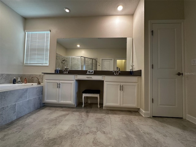 bathroom with dual vanity, separate shower and tub, and tile patterned flooring