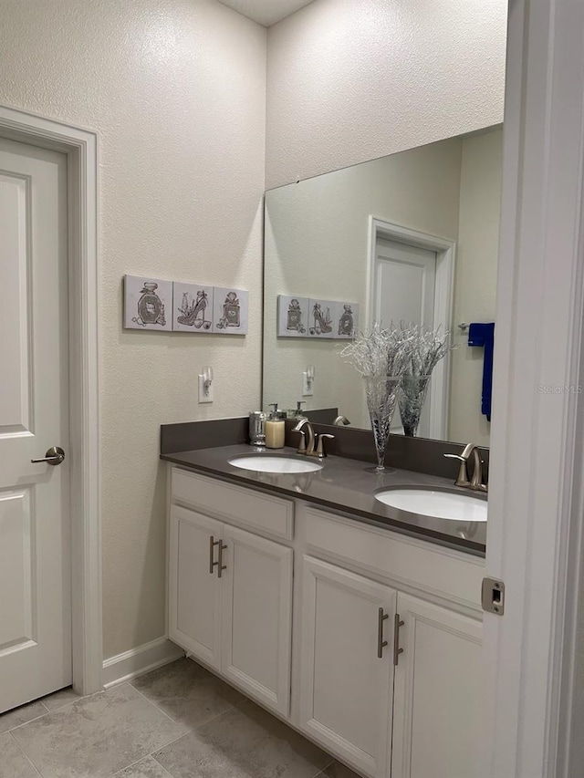 bathroom featuring tile patterned floors and dual bowl vanity