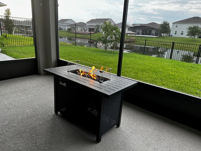 sunroom / solarium featuring a water view