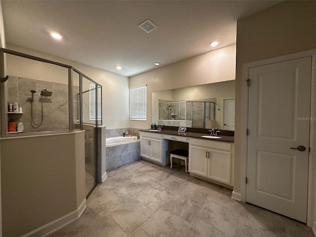 bathroom with vanity, baseboards, visible vents, a shower stall, and a garden tub