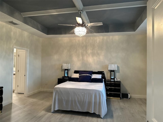 bedroom with a tray ceiling, light wood-type flooring, and ceiling fan