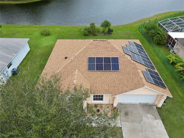 birds eye view of property with a water view