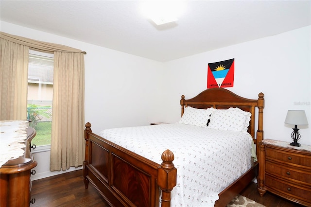 bedroom with dark wood-type flooring