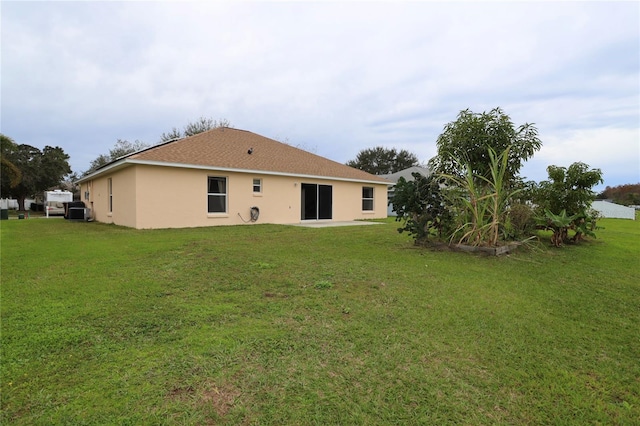 rear view of property with a lawn