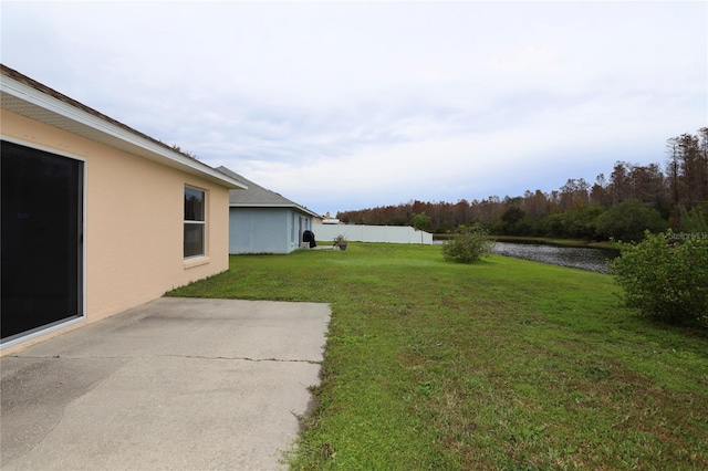 view of yard with a patio area and a water view