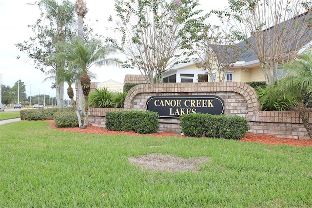 community / neighborhood sign with a lawn