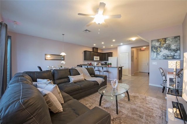 tiled living room with ceiling fan