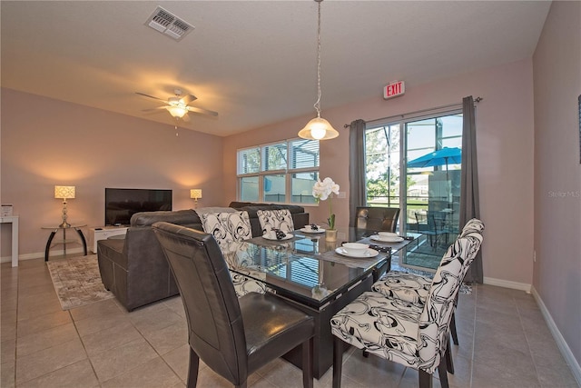3171 Tocoa Cir, Kissimmee, FL 34746 - dining space featuring plenty of natural light, ceiling fan, light tile patterned floors, and baseboards