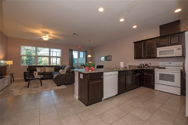 kitchen with dark brown cabinets, kitchen peninsula, ceiling fan, and white appliances