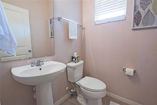 bathroom with tile patterned flooring and toilet