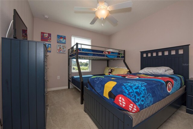 3171 Tocoa Cir, Kissimmee, FL 34746 - bedroom featuring light carpet, baseboards, and a ceiling fan