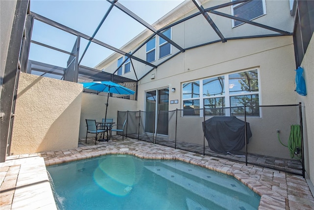 3171 Tocoa Cir, Kissimmee, FL 34746 - view of pool featuring a patio, area for grilling, glass enclosure, and outdoor dining space